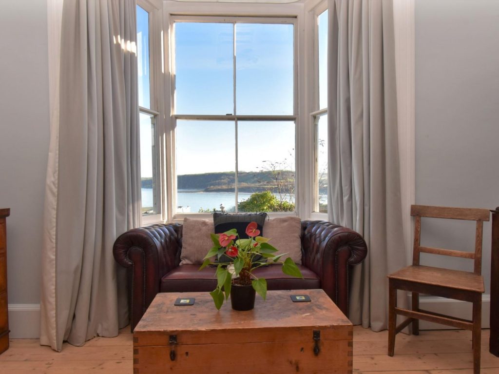 Window seat with sea view in open plan kitchen / dining room Window seat with sea view in open plan kitchen / dining room