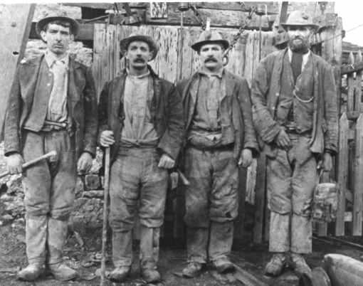 Miners with their candle lights in their hats